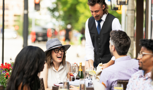 People enjoying happy hour on the outdoor patio at Mason Street Grill